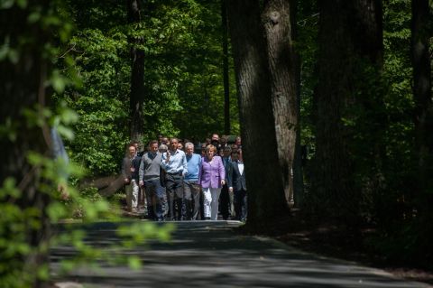 Cameron, Obama, Monti and Merkel take a stroll through the grounds of Camp David on their way to a group photo shoot.