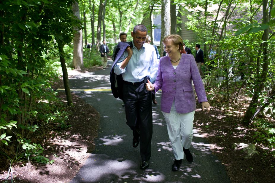 Obama and Merkel talk as they walk to Aspen Cabin.