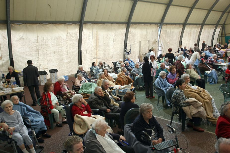 Elderly people rest after being evacuated to a sports center in Finale Emilia after the quake. 