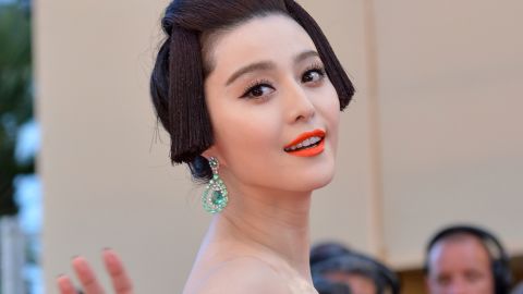 Chinese model Fan Bingbing waves from the red carpet ahead of the opening ceremony on May 16.