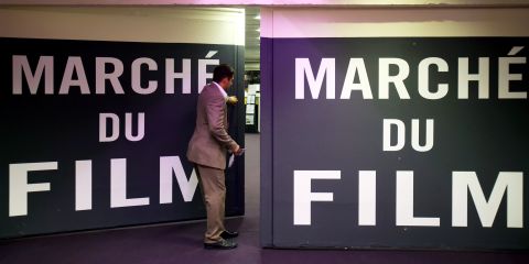A worker closes a door at the Marche du Film market on the sidelines of the Cannes film festival on Sunday.