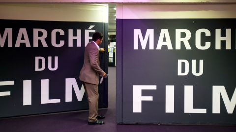 A worker closes a door at the Marche du Film market on the sidelines of the Cannes film festival on Sunday.