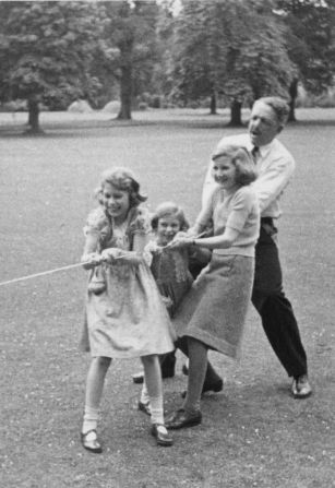 Rhodes playing in a tug of war with Princess Elizabeth and her sister, Princess Margaret.