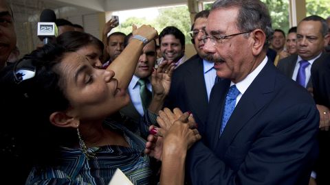 Danilo Medina, right, greets a supporter at a polling station in Santo Domingo on Sunday.