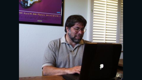 Apple co-founder Steve Wozniak using a Powerbook with the "upside-down" logo.