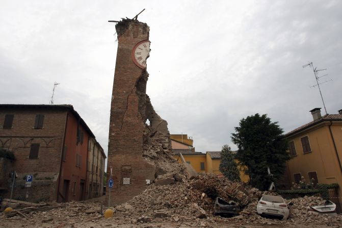 The tower crumpled to ground after the quake, destroying the cars parked below it as it flooded the street with bricks.