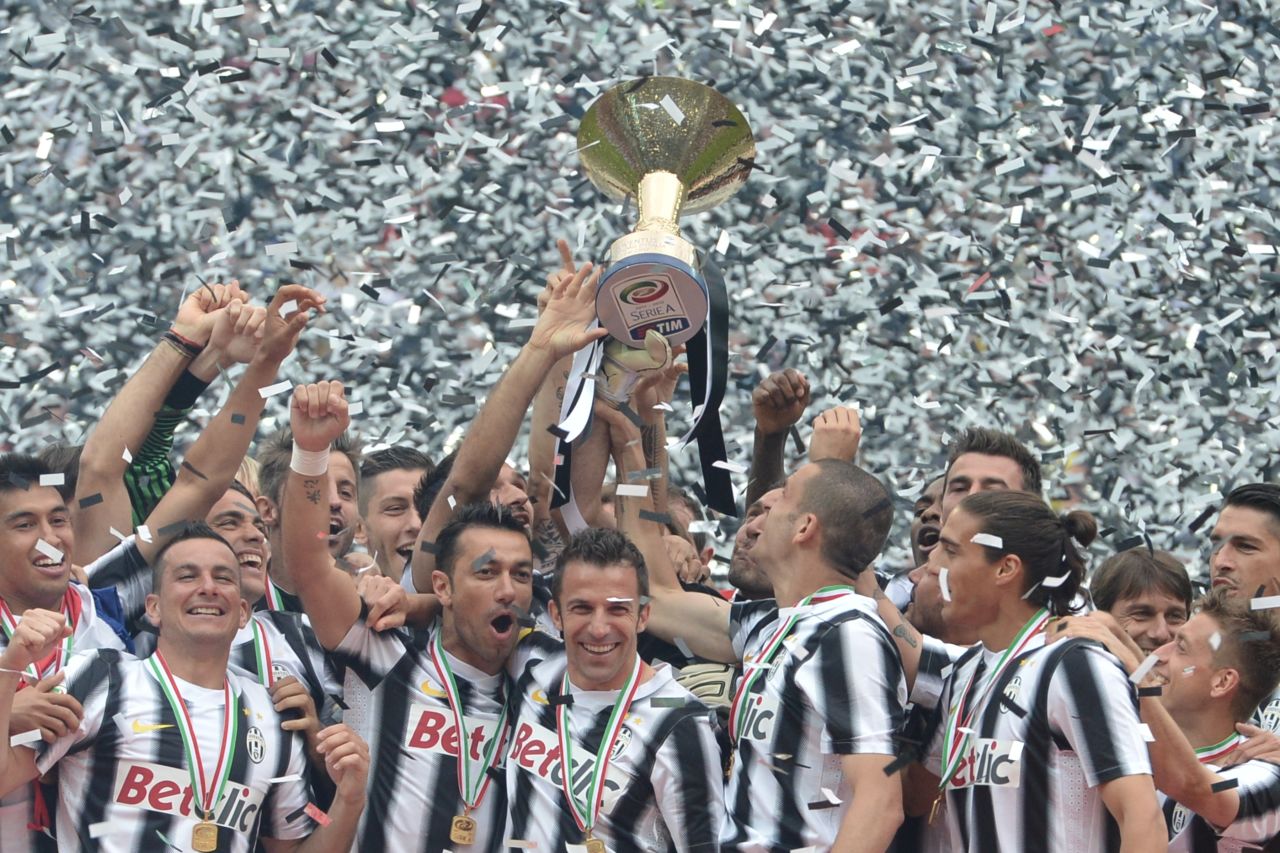 Juventus players celebrate their Serie A title success after going through the 2011-12 league season unbeaten to relegate arch-rivals AC Milan to second place.