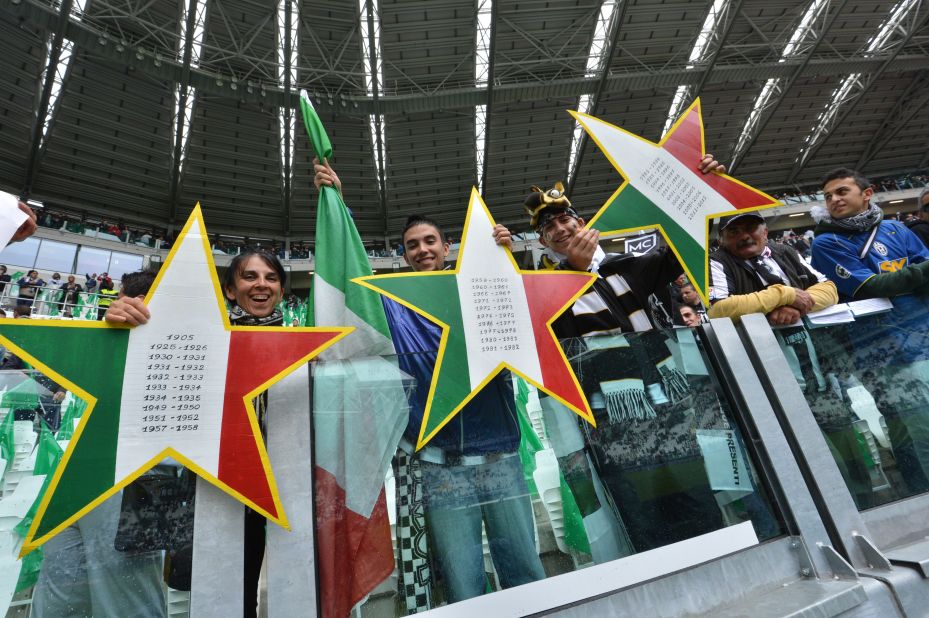 Juventus fans hold up three stars to signify the 30 championships won by the club, but two in 2005 and 2006 have been struck off the official records after the "Calciopoli" match-fixing scandal.