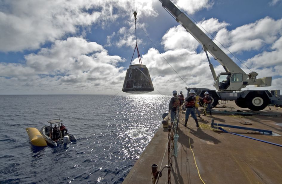 The first Dragon capsule to make it into orbit and return to Earth was launched in December 2010. Here, crews haul the charred capsule out of the ocean.
