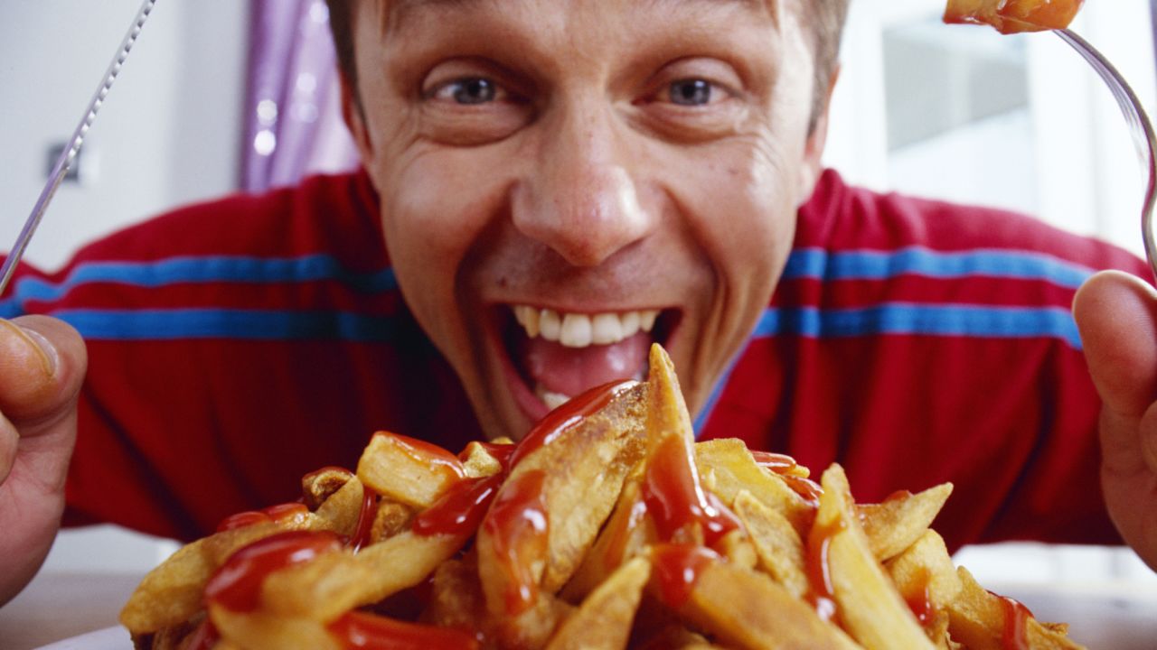 man eating french fries