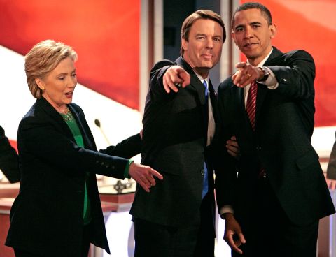 Presidential hopefuls Hillary Clinton, Edwards and Barack Obama point to supporters and family members in the audience after a debate in New Hampshire in January 2008.