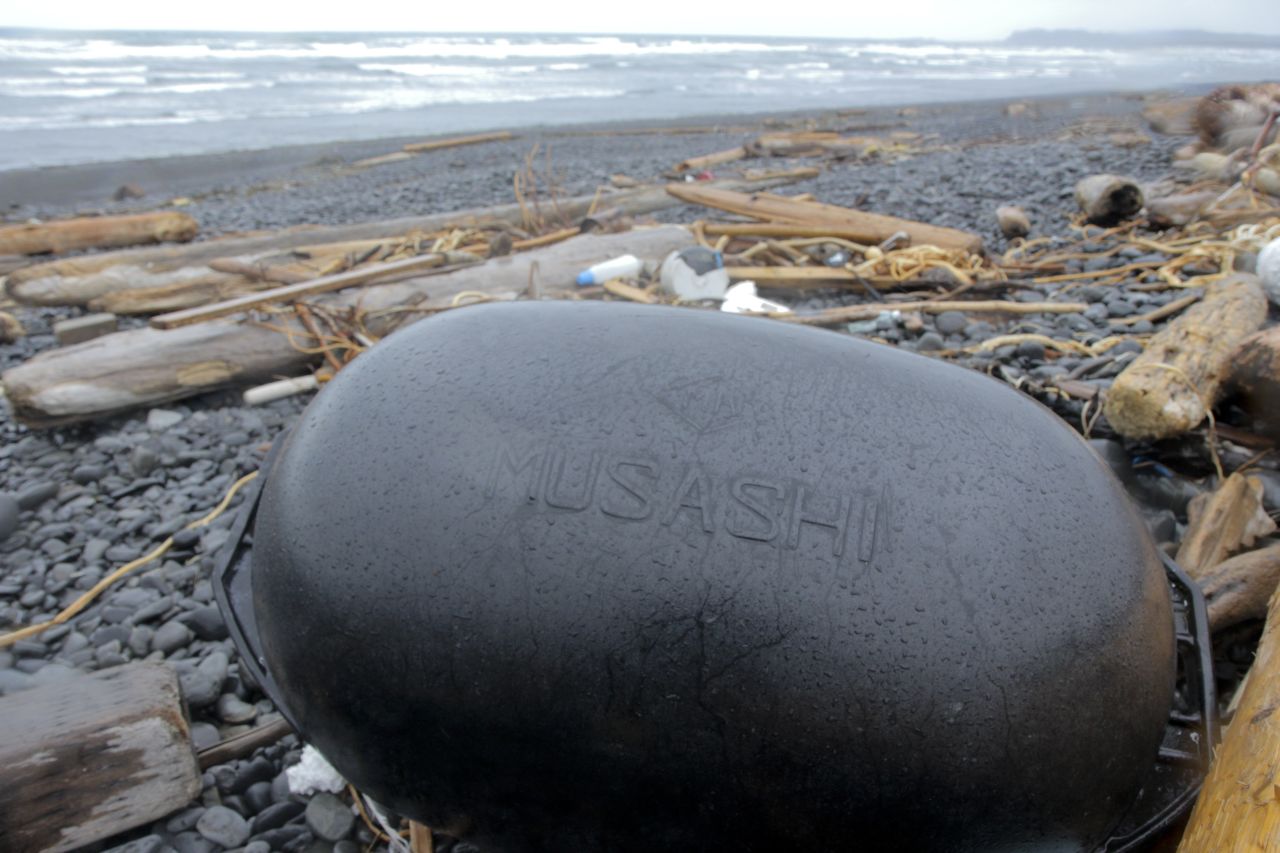 A plastic float bearing the Japanese name "Musashi" is among the rubbish on Montague Island.