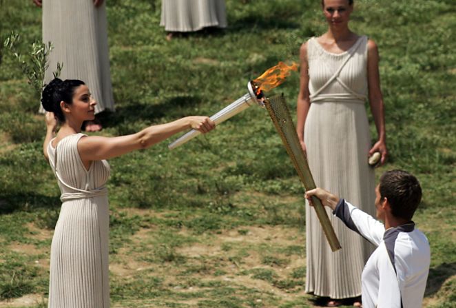 Amid the tumbledown columns and olive groves of the ancient stadium in Olympia, Greece, the 2012 flame is lit. Actor Ino Menegaki played the high priestess in the traditional ceremony on May 10.