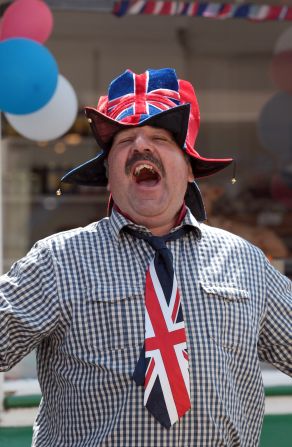 A Porlock resident gets into the Olympic spirit as the torch passes through his town on day three of the relay. Crowds have turned out in their hundreds to cheer on the flame as it makes its 8,000-mile journey across the UK. 