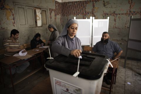 An Egyptian Coptic nun drops her ballot at a Cairo polling station Wednesday. 