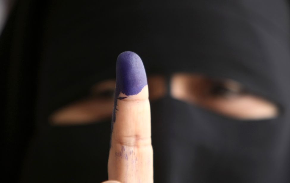 An Egyptian woman holds up an ink-stained finger after casting her ballot in Cairo on Wednesday, May 23, the first day of voting in the historic election. 