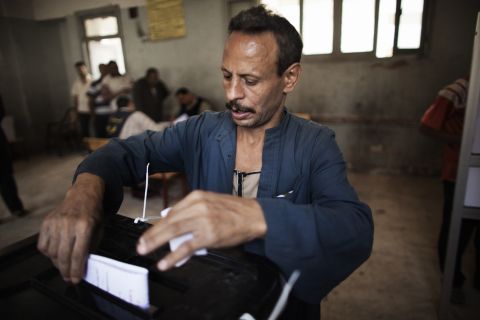 An Egyptian man casts his ballot at a Cairo polling station. Some Egyptians told CNN that they waited up to four hours Wednesday to vote.
