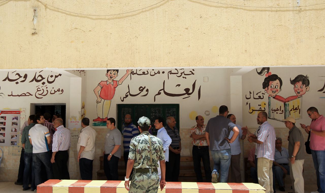 Egyptian men line up to cast their vote Wednesday in Cairo. Some 30,000 volunteers fanned out to ensure voting is fair, said organizers with the April 6 youth movement, which has campaigned for greater democracy in Egypt.