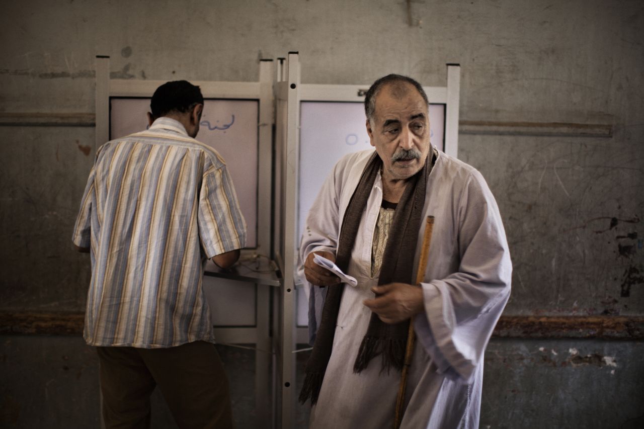 Egyptian men fill out their ballots at a Cairo polling place.