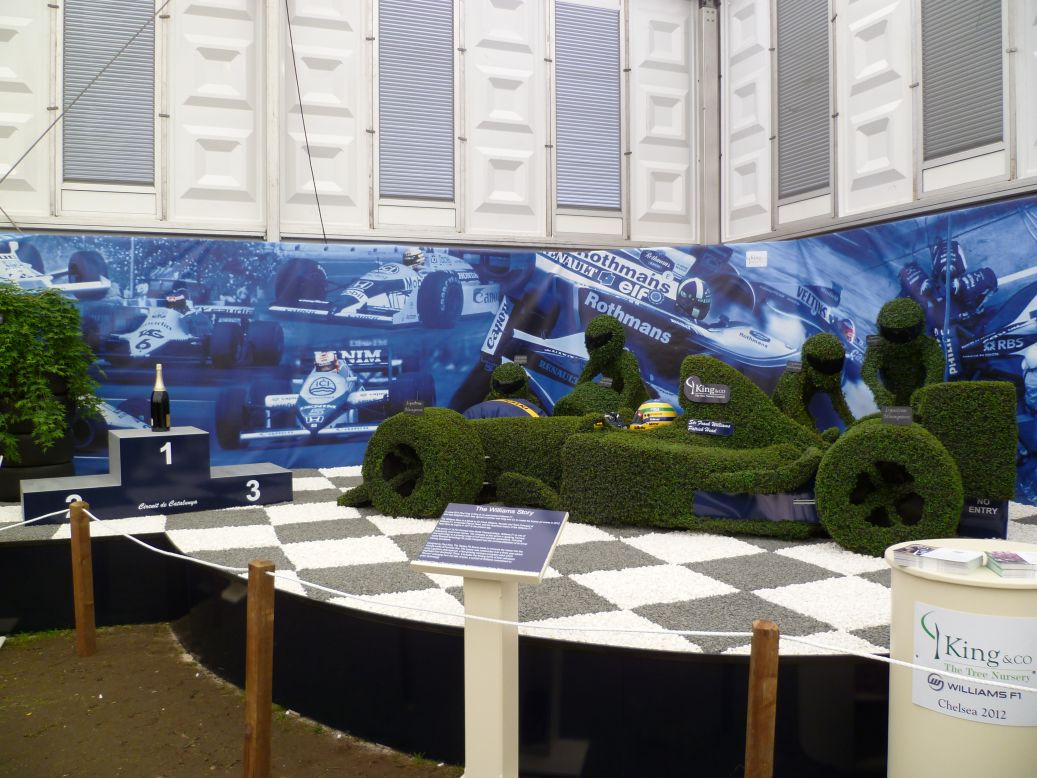 The display at London's Chelsea Flower Show was awarded the prestigious gold medal. The topiary features a life-size F1 car and pit crew.