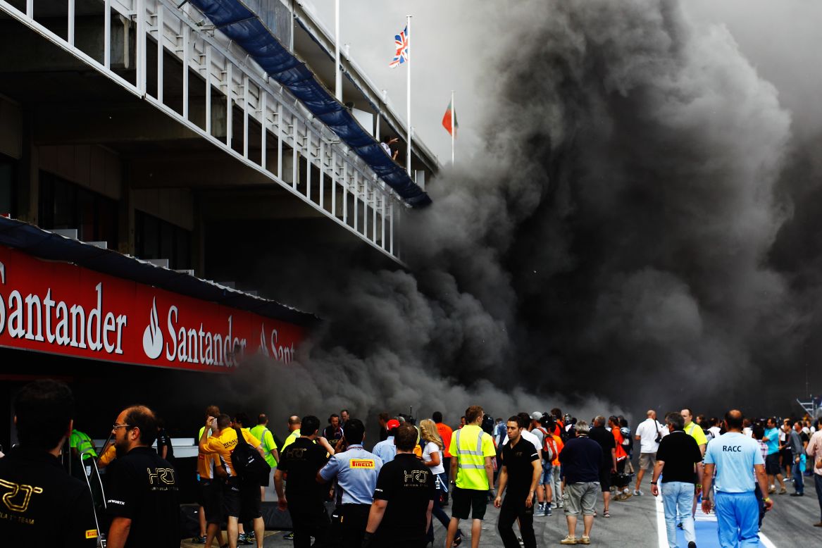 The team's post-race celebrations were cut short by a fire in their garage, and smoke from the blaze engulfed the pit lane at the circuit in Catalunya.