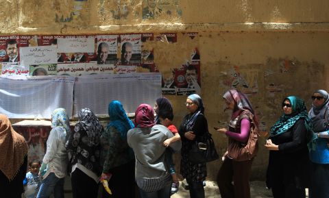 Egyptian women wait in line Thursday to cast their vote outside a polling station in Cairo. If no candidate gets a majority of the vote in the first round of voting, a second round will be held June 16-17. 