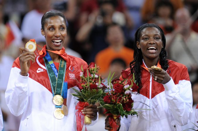 Lisa Leslie, left, proudly displays the four gold medals she won after collecting the last at the 2008 Beijing Olympics.
