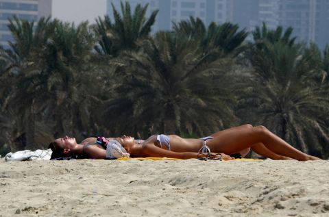 The expectation for foreign women is more relaxed, and it is acceptable for them to wear bikinis on beaches, such as at Dubai Marina.