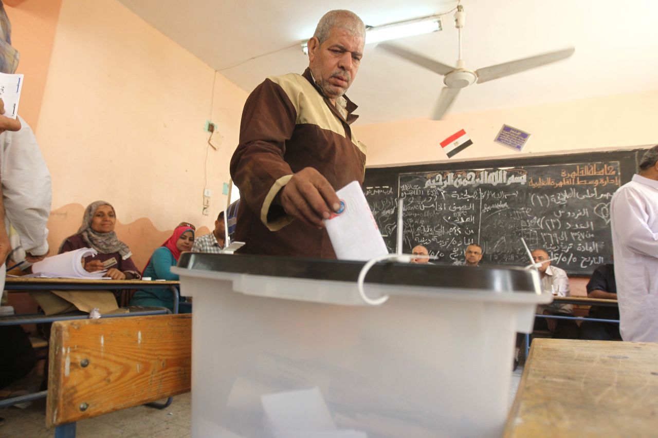 An Egyptian man drops off his ballot at a polling station Thursday in Cairo. The voting marks the first time Egypt has held a presidential election in which the results aren't known beforehand.