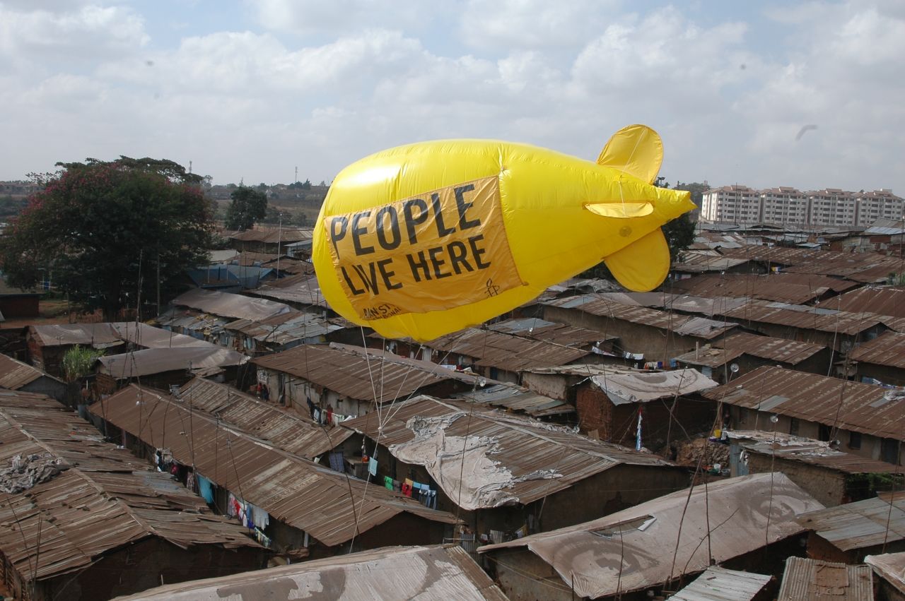 Residents and activists in an informal settlement facing forced eviction in Nairobi, Kenya walk a huge balloon down a railway line in March 2012 during a week of action against forced evictions.