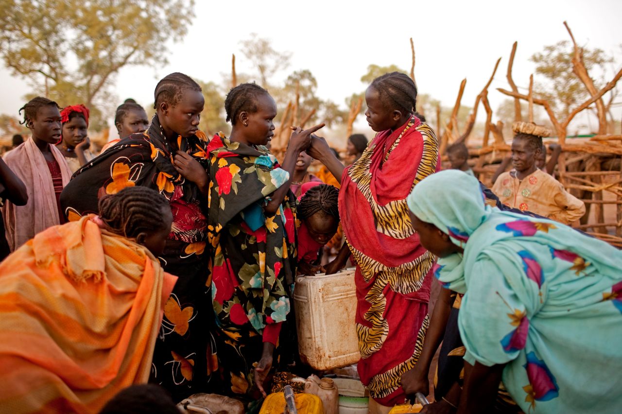 Two Nuba women argue at a water point in the Yida refugee camp, South Sudan, in April 2012. Water is in extremely short supply in the camp, which has daily temperatures of more than 115 degrees. Women and children often stand in line for up to 10 hours to fill one jerry can.