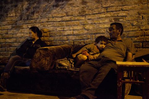 A woman, her neighbor and his son sit near the property they used to live in. They were forcibly evicted from Skadarska street settlement, Belgrade, Serbia, in August 2011 and ended up on the street.