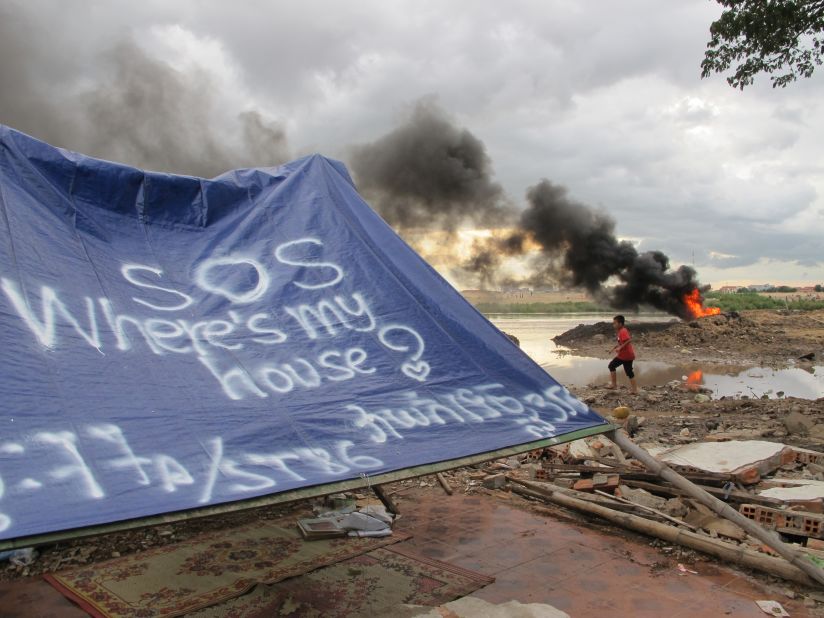 Residents of eight destroyed homes put up a tarpaulin where they used to live. 
