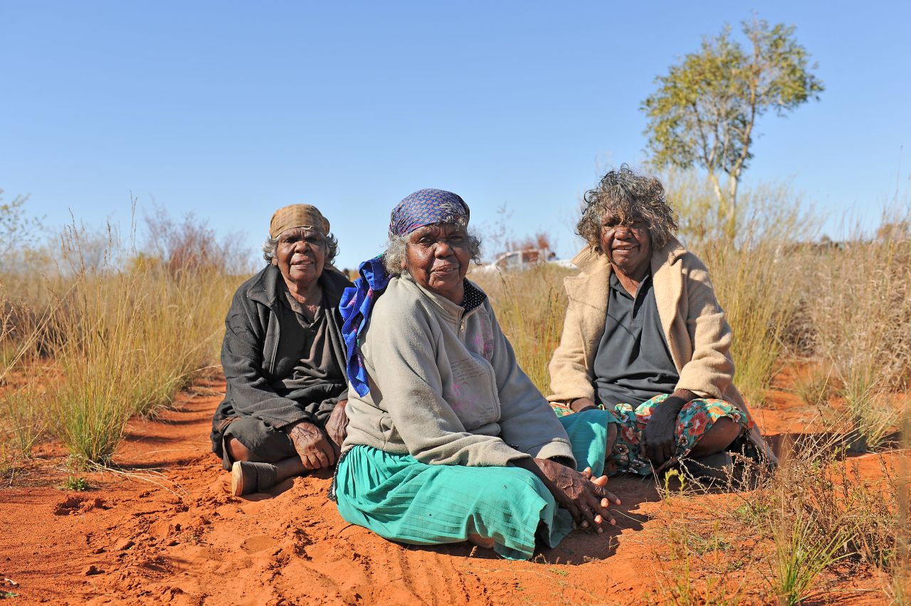 Three sisters on their traditional land at Mosquito Bore, near the track of the dreaming story of the Mountain Devil Lizard, Utopia homelands, Northern Territory, Australia. 