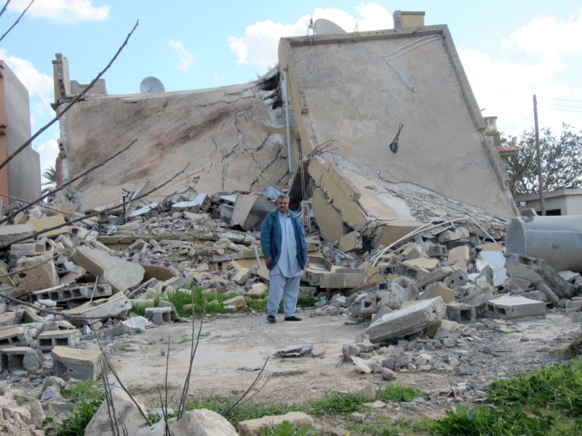 Mustafa Naji al-Morabit by the ruins of his home in Zlitan, Libya, in February 2012. It was struck on August 4, 2011by a NATO airstrike. He told Amnesty International: "My family has been destroyed; I lost my two little boys and my wife, Ibtisam, who was also my best friend. It is really difficult to go on, to get up every day and face life; I tell myself that I must find the strength for my son, the only child I have left." 