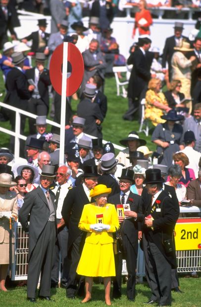 Her Majesty pictured with race goers during the Ever Ready Derby at Epsom racecourse in Epsom, England. It is said in racing circles that the British sovereign's reading material of choice over her breakfast is the Racing Post.
