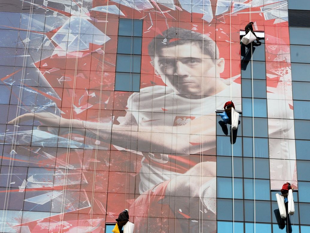 Poland will co-host the 2012 European Championship with Ukraine. Here, workers unfurl a banner of Poland's Germany-based striker Robert Lewandowski. The national team has had little to cheer about in recent years and slumped to 75th in FIFA's world rankings, their lowest ever position. But it hasn't always been that way.