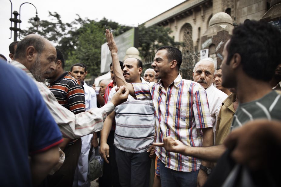Supporters of various candidates debate outside Al-Fatah Mosque in Cairo on Friday.