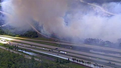 Smoke from a brush fire closed sections of highway in Orange County, Florida.