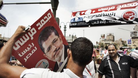 A supporter of the Muslim Brotherhood's presidential candidate holds a campaign poster in Cairo Friday. 