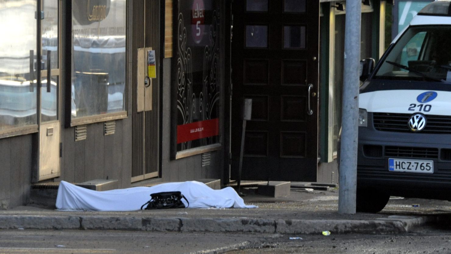 The body of a shooting victim lies on the ground where a gunman opened fire in Hyvinkaa, Finland, on Saturday. 