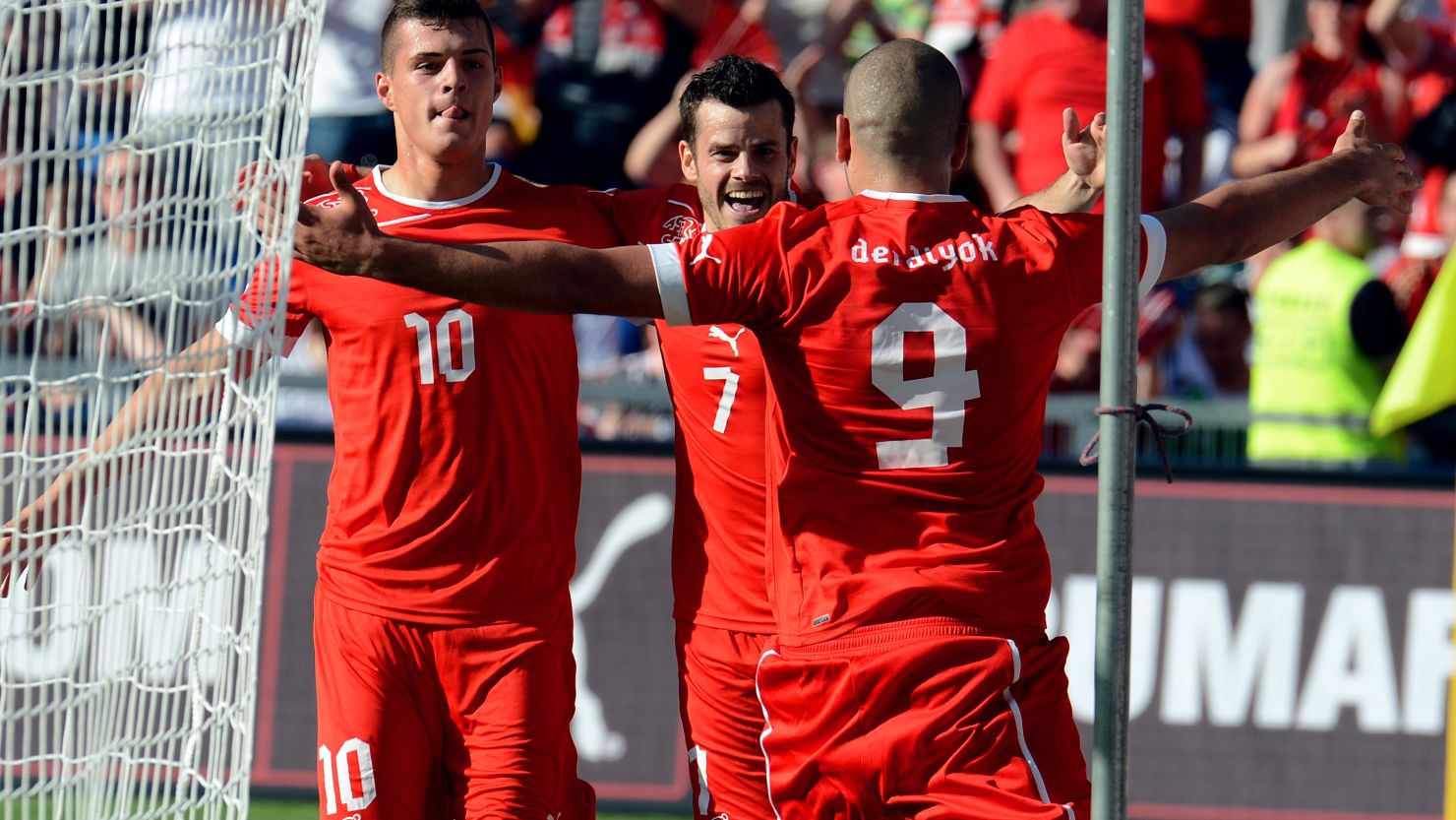 Eren Derdiyok gets the congratulations of teammates on his way to a hat-trick in Switzerland's 5-3 win over Germany.