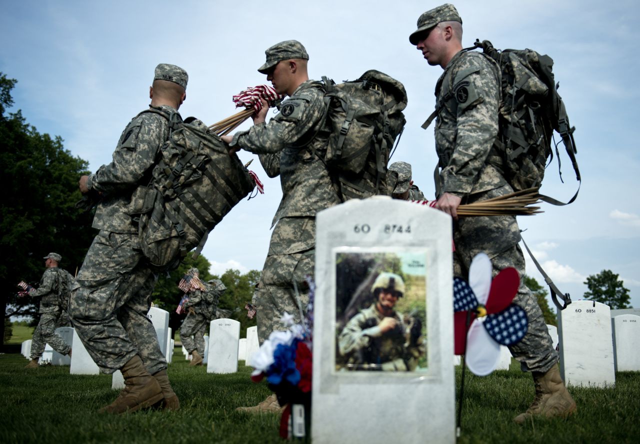 Soldiers at Arlington National Cemetery on Thursday pass the grave of U.S. Army Lt. Thomas Brown, who served in Iraq and died in 2008.