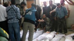 handout picture released by the Syrian opposition's Shaam News Network shows UN observers at a hospital morgue before their burial in the central Syrian town of Houla on May 26, 2012. The head of a UN mission warned of "civil war" in Syria after his observers counted more than 92 bodies, 32 of them children, in Houla following reports of a massacre there. AFP PHOTO / SHAAM NEWSSHAAM NEWS/AFP/GettyImages