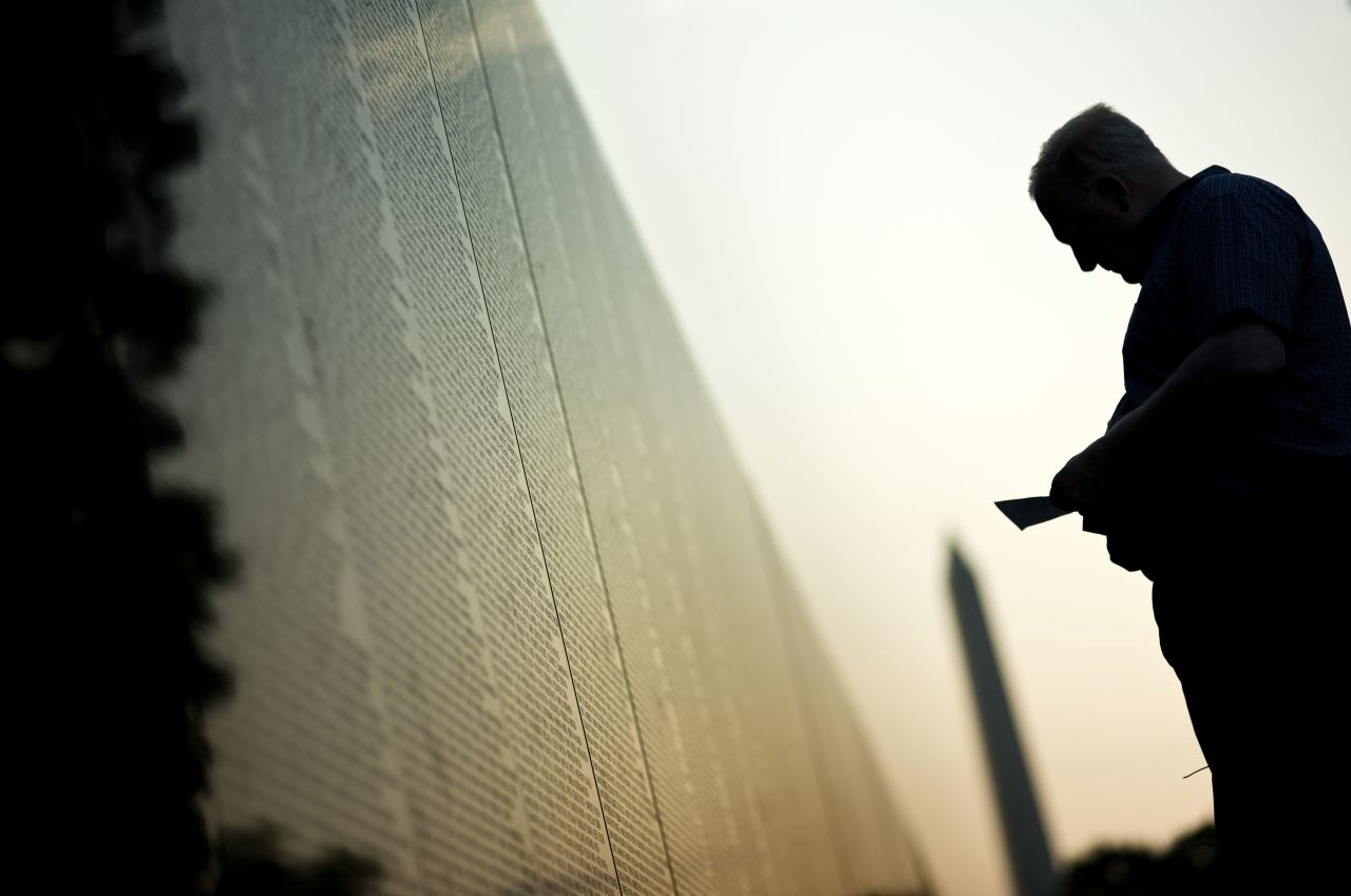 A man visits the Vietnam Veterans Memorial Wall early Monday in Washington. 