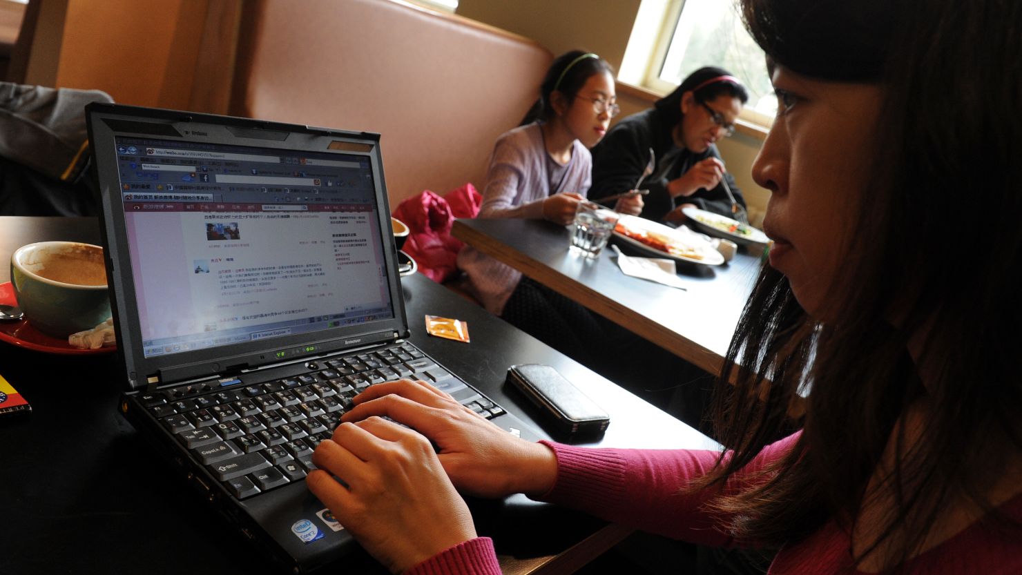 A woman views the Chinese social media website Weibo at a cafe in Beijing in April.