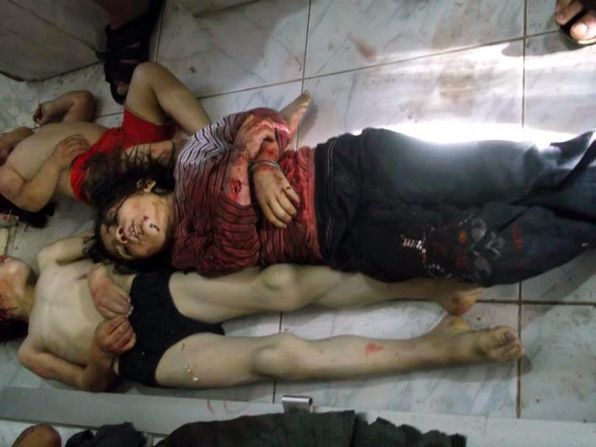 Bodies of children lie in a Houla hospital morgue before their burial Saturday in another photo from Shaam News Network. Images from the town show a room crammed with mangled and bloody bodies of children -- some with their skulls torn open.