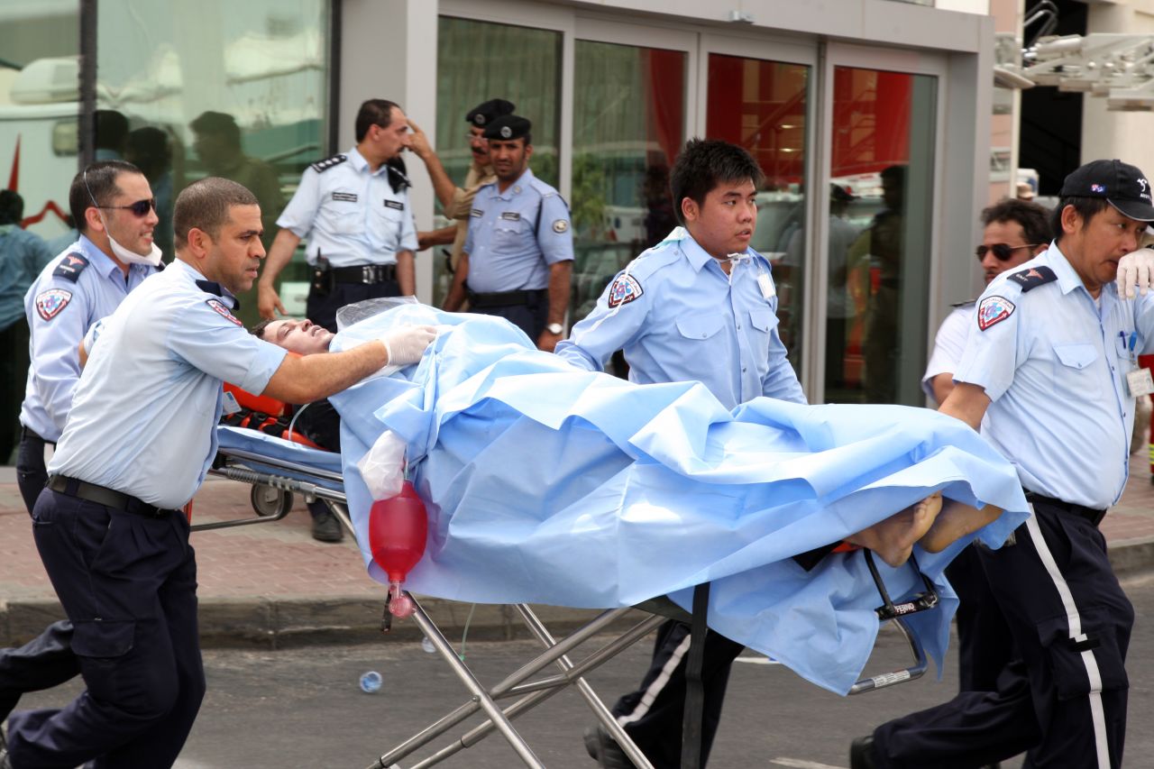 A survivor receives medical care outside of the Villaggio mall. More than a dozen people were injured.