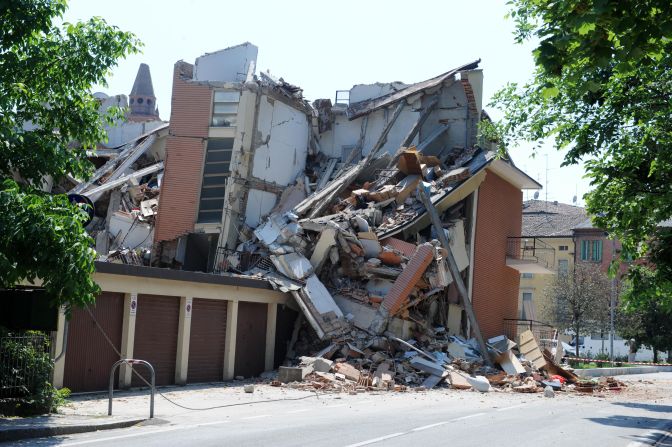 Personal belongings from a collapsed building are strewn across a street in Cavezzo, where eyewitnesses say about 70% of the town was destroyed.