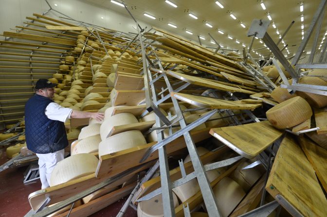 Hundreds of blocks of cheese fell on top of one another at a parmigiano factory in San Giovanni, Parsiceto. The owner of the factory surveys the damage on May 21, 2012, following an earlier quake.